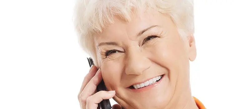 country club dentist crowns norhtern arizona - smiling person talking on mobile phone