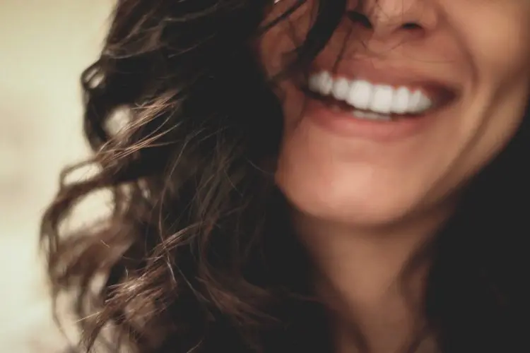 Properly Floss Your Teeth - close up of teeth and face
