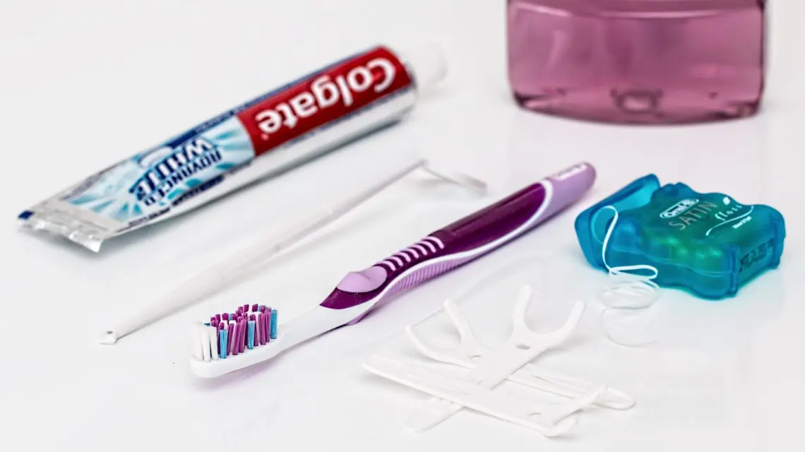 floss daily - toothpaste, toothbrush, floss thread all laid out