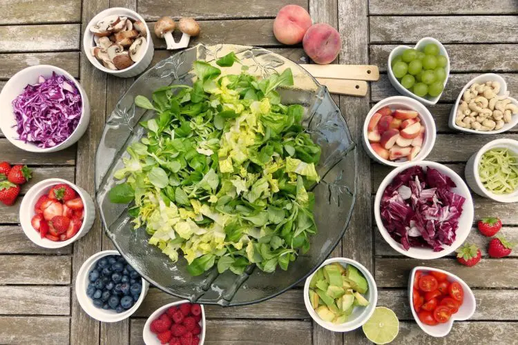 nutrition for healthy teeth - various bowls with cut vegetables and fruits
