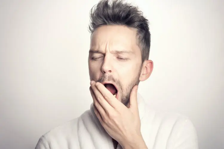how to stop grinding teeth - man with jaw pain