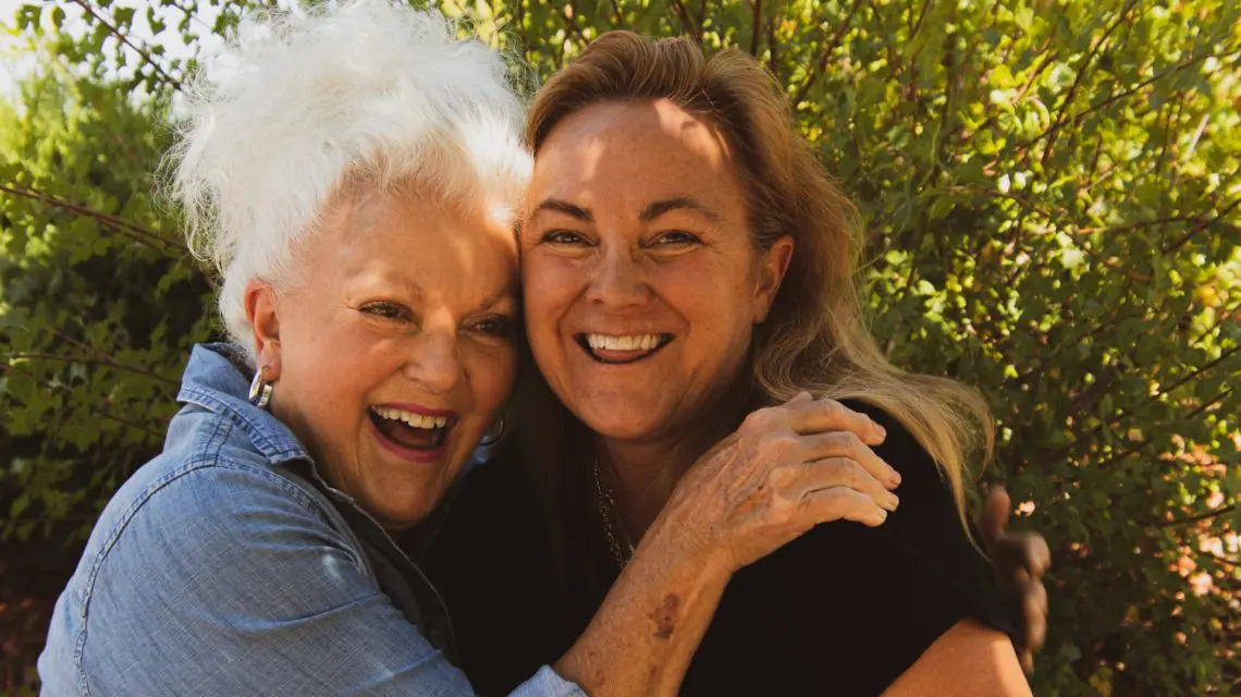 two women hugging and smiling