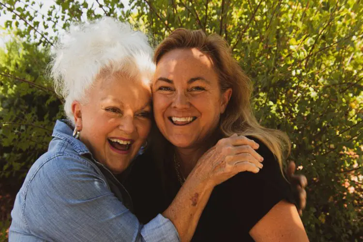 two women hugging and smiling
