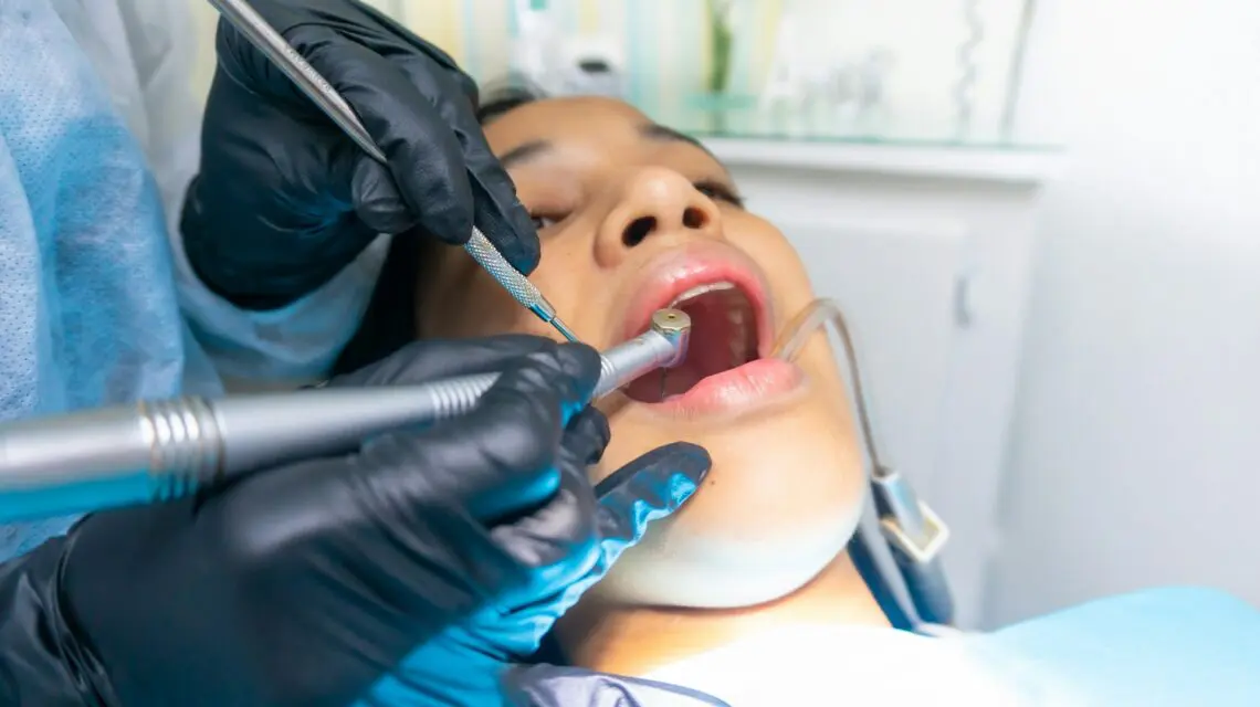 person getting a dental cleaning -why are dental checkups important
