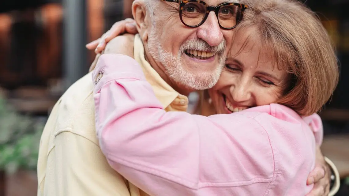 senior couple hugging and smiling