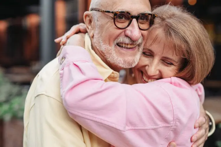 senior couple hugging and smiling