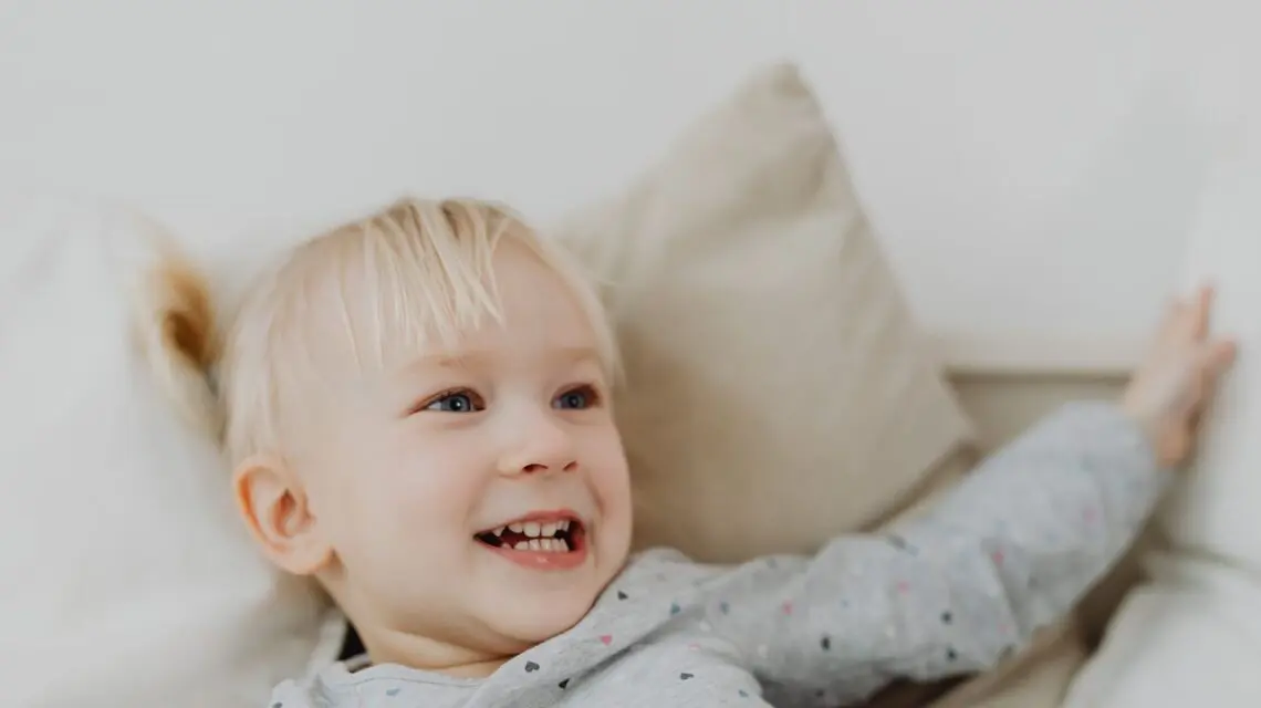 toddler smiling showing baby teeth