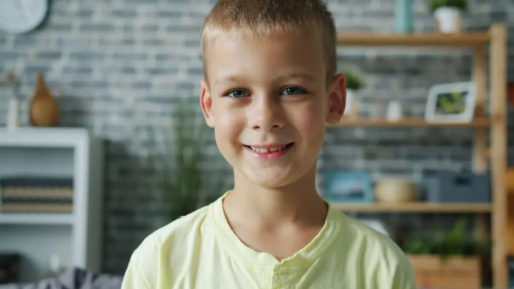 young boy smiling in living room