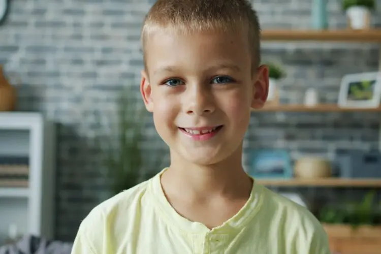 young boy smiling in living room