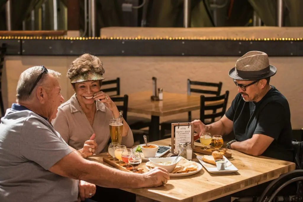 group of older friends at a table eating lunch