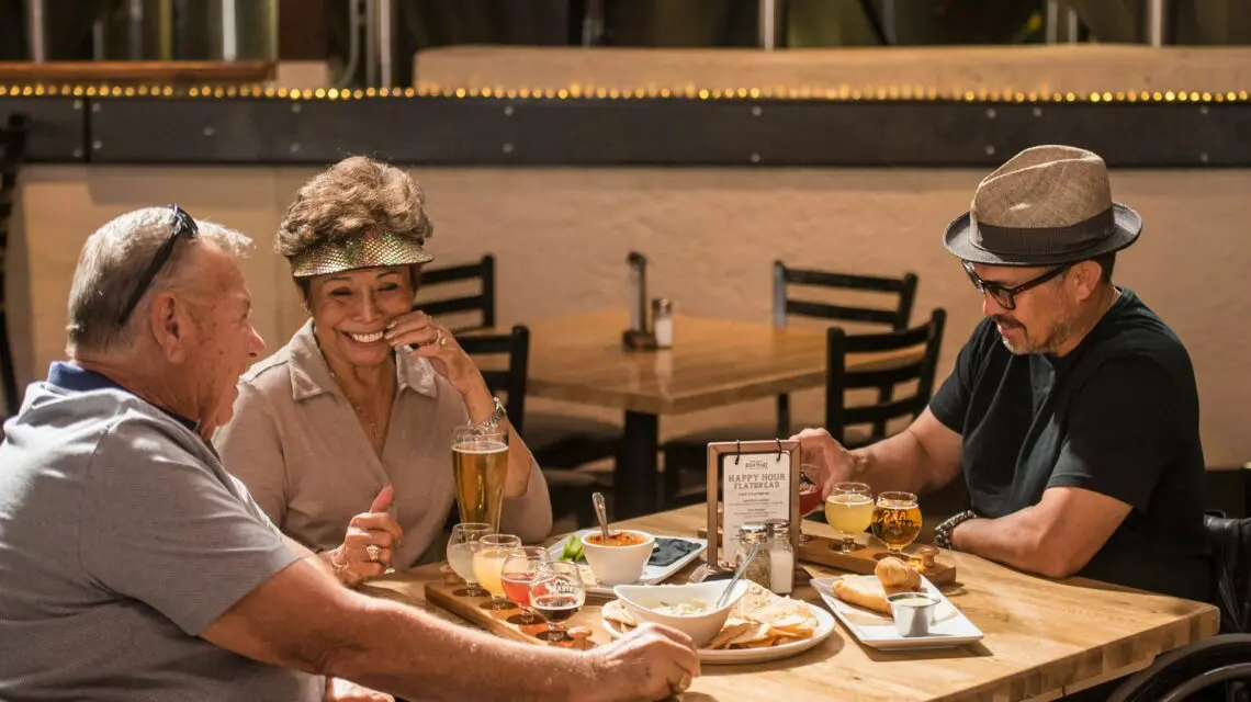 group of older friends at a table eating lunch