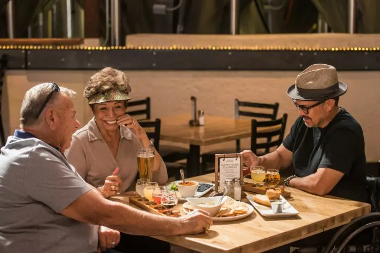 group of older friends at a table eating lunch