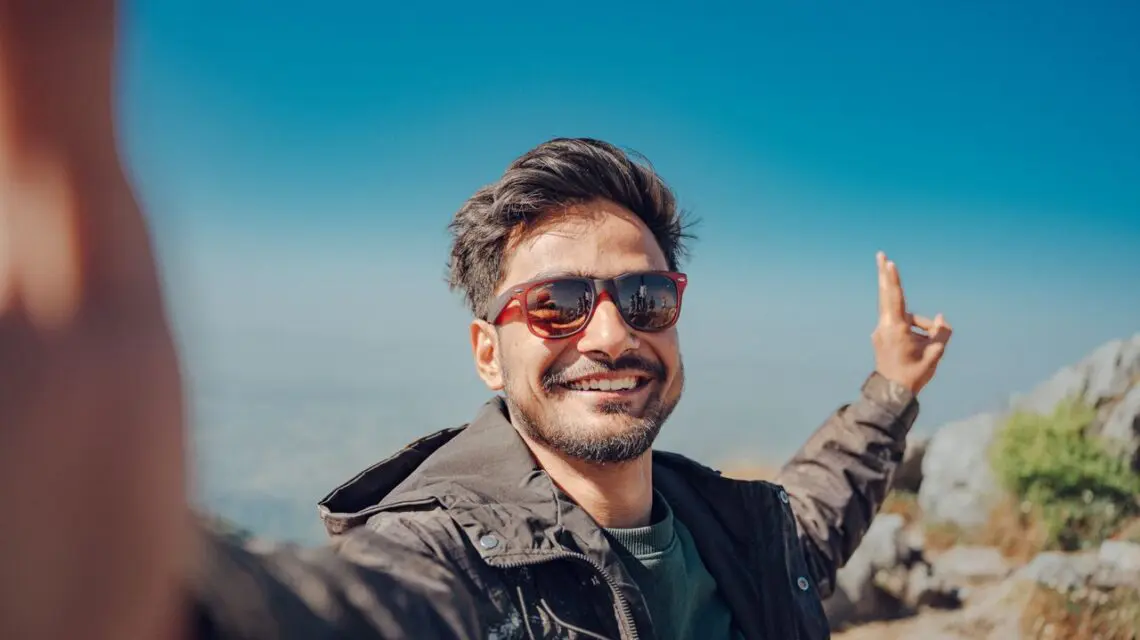 man smiling hiking mountain