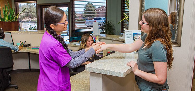Country Club Dental Flagstaff AZ Tooth - person greeting another at reception desk