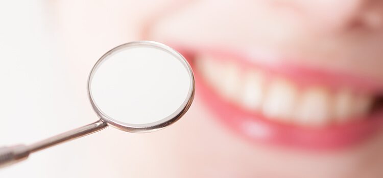 country club dental fillings coconino arizona - close up of dental mirror in front of a mouth