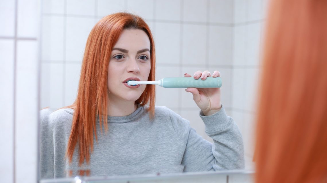 brushing teeth wrong - woman brushing teeth