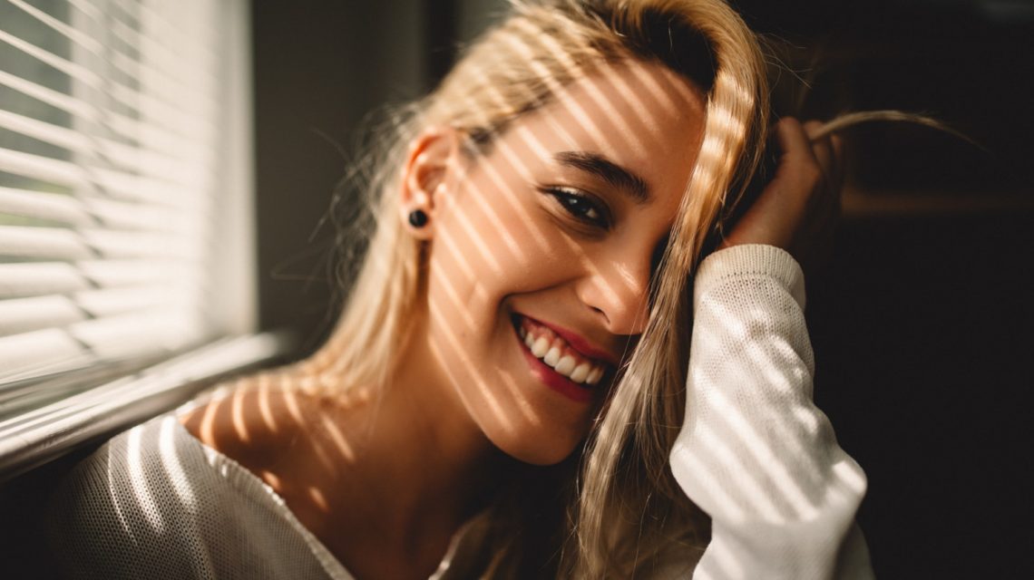 blonde woman smiling - how to keep gums healthy