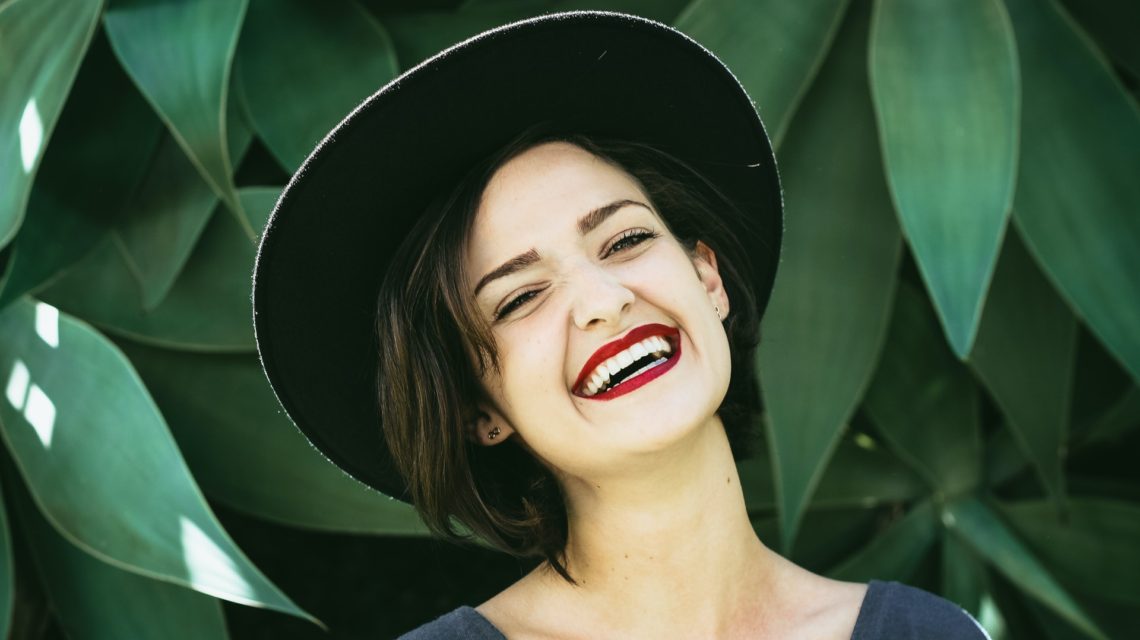 teeth whitening - girl smiling with hat