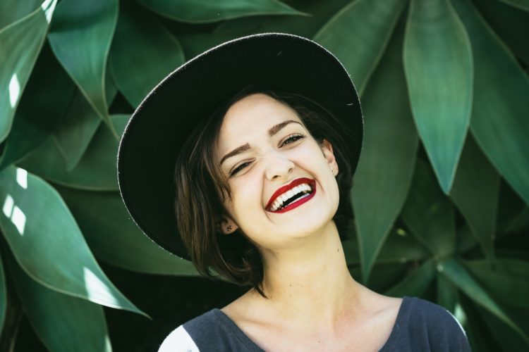 teeth whitening - girl smiling with hat