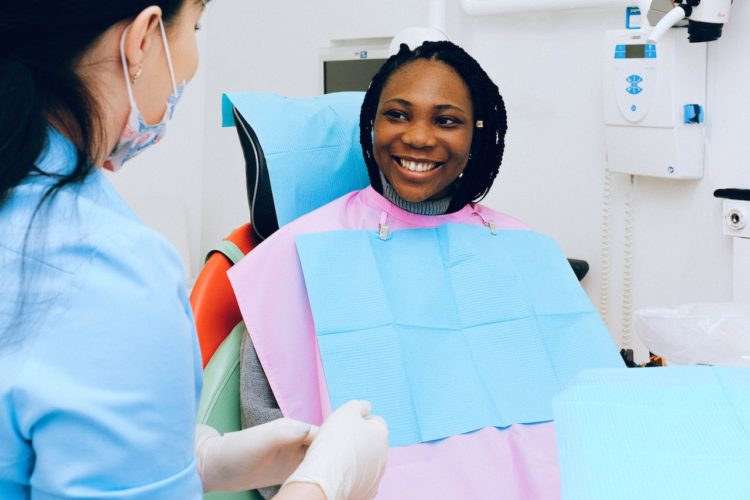 woman in dentists chair smiling at dentist