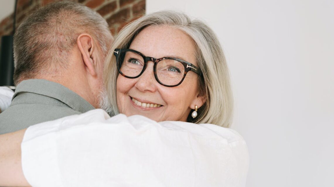 older woman smiling hugging husband