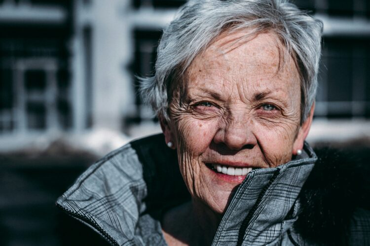 older woman smiling in winter coat