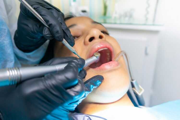 person getting a dental cleaning -why are dental checkups important