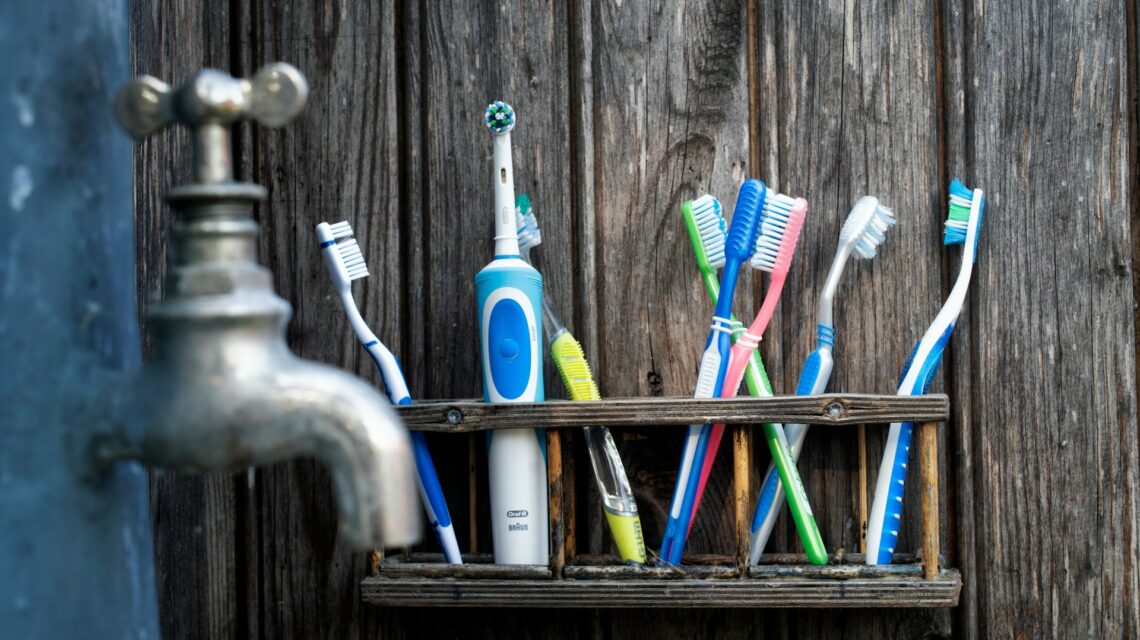 many toothbrushes on a shelf - are electric toothbrushes better