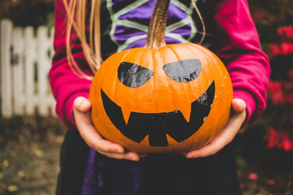 child holding a jack-o-lantern - preventing cavities in children