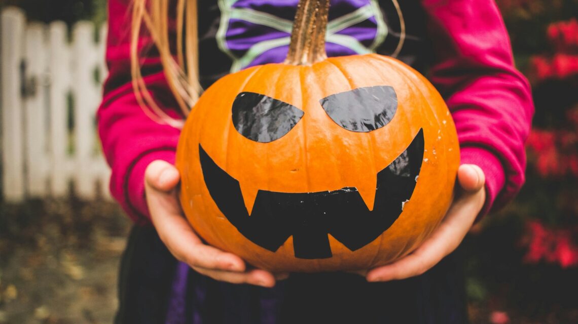 child holding a jack-o-lantern - preventing cavities in children