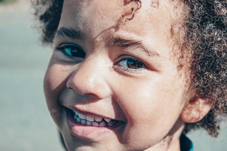 child with large smile - choosing a toothbrush for a child